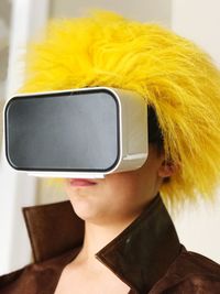 Close-up of woman with dyed hair wearing virtual reality simulator