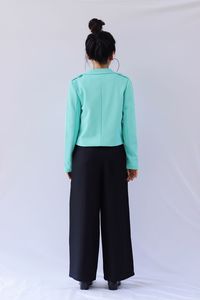 Rear view of woman standing against white background