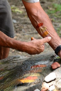 Close-up of man hand on rock