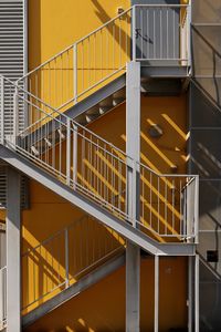 Fire escape staircase against yellow wall