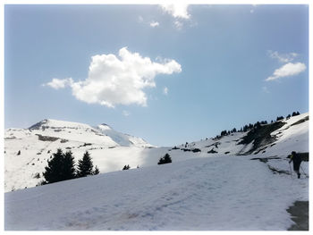 Snow covered landscape against sky