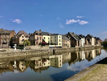 Reflection of buildings in lake against sky