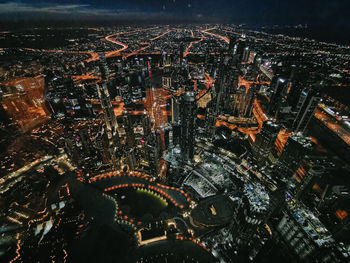 High angle view of city lit up at night