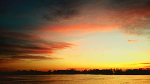 Scenic view of lake against sky during sunset