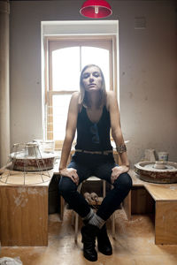 Portrait of woman sitting on table