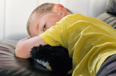 Boy lying on sofa