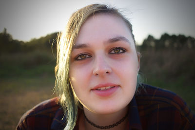 Close-up portrait of smiling young woman