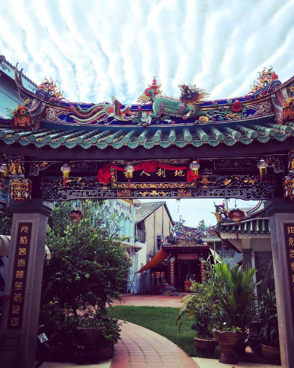 architecture, built structure, building exterior, sky, place of worship, religion, tree, temple - building, spirituality, cloud - sky, roof, low angle view, tradition, cultures, ornate, pagoda, travel destinations, cloud, traditional