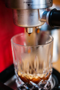 Close-up of coffee pouring in glass