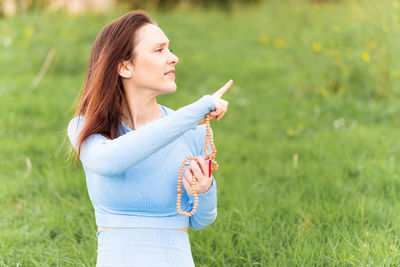 Young woman standing on field