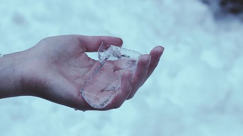 Close-up of hand holding ice