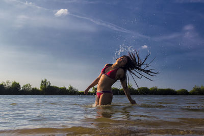 Full length of woman at beach against sky