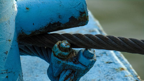 Close-up of rope tied up on metal