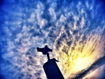 Low angle view of statue against cloudy sky