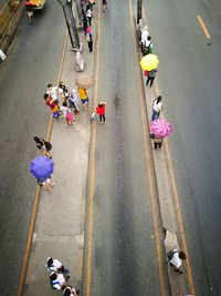 High angle view of people walking on road