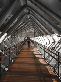 Low angle view of woman on footbridge