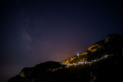 Scenic view of mountains against sky at night