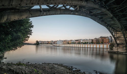 Triana bridge over guadalquivir river during sunset