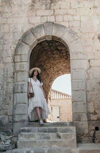 Portrait of woman exploring old medieval settlement inside a fortress of klis near split in croatia.