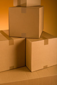 Stack of cardboard boxes against colored background