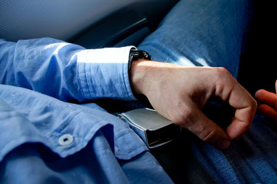 Midsection of man sitting in car