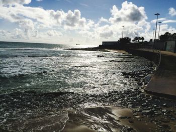 Scenic view of sea against cloudy sky