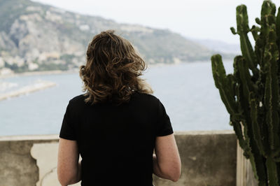 Rear view of woman looking at waterfall