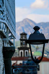 Close-up of cross on building against sky