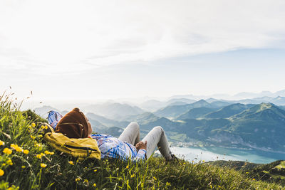 Austria, salzkammergut, hiker taking a break, looking over the alps