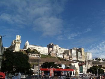 Buildings in city against blue sky