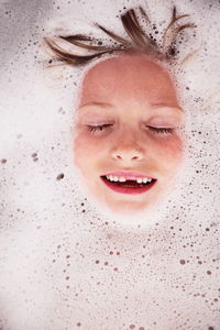 Portrait of young boy bathing