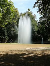 Scenic view of waterfall against sky