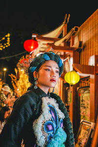 Young woman looking away at night