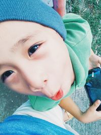 High angle view of cute boy making face