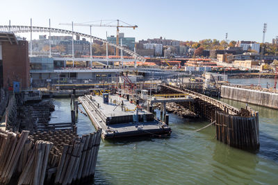 High angle view of harbor by river against sky