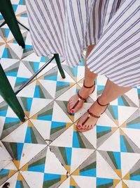Low section of woman holding umbrella