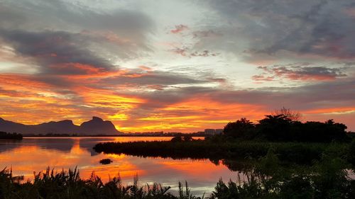 Scenic view of lake against sky during sunset