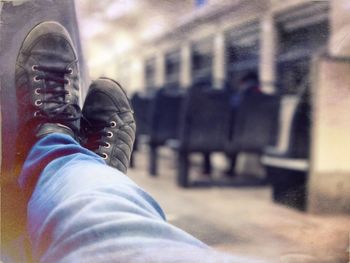 Low section of man standing on train