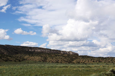 Countryside landscape against cloudy sky