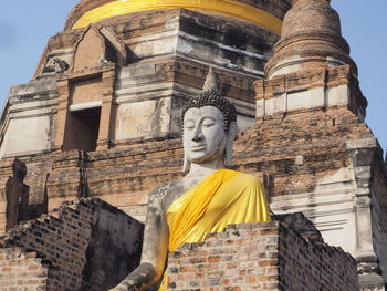 Low angle view of statue against historic building