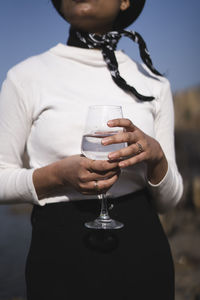 Midsection of woman holding ice cream