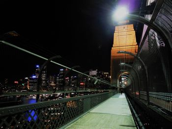 Illuminated bridge in city at night