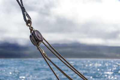 Low view of sailboat sailing on sea against sky in iceland, husavik, full power ahead