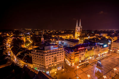 Illuminated cityscape against sky at night