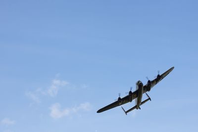 Low angle view of airplane flying against sky