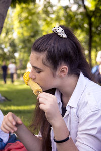 Close-up of young woman eating food