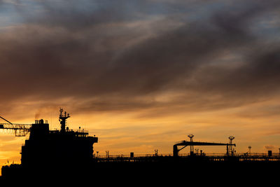 Silhouette of an oil tanker at sunset
