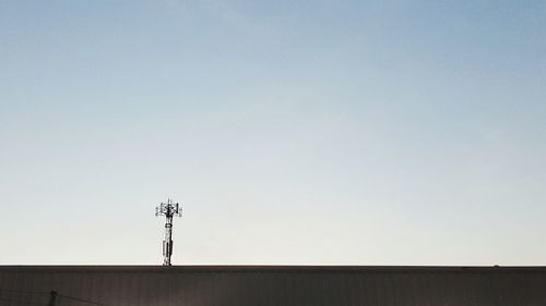 Low angle view of communications tower against clear sky