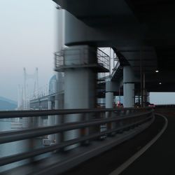 Bridge over factory against sky