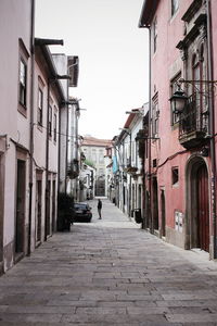 Empty alley amidst buildings in city